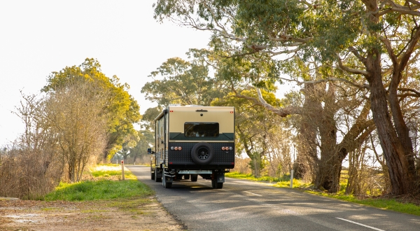 Australian Campers Caravan behind White Car